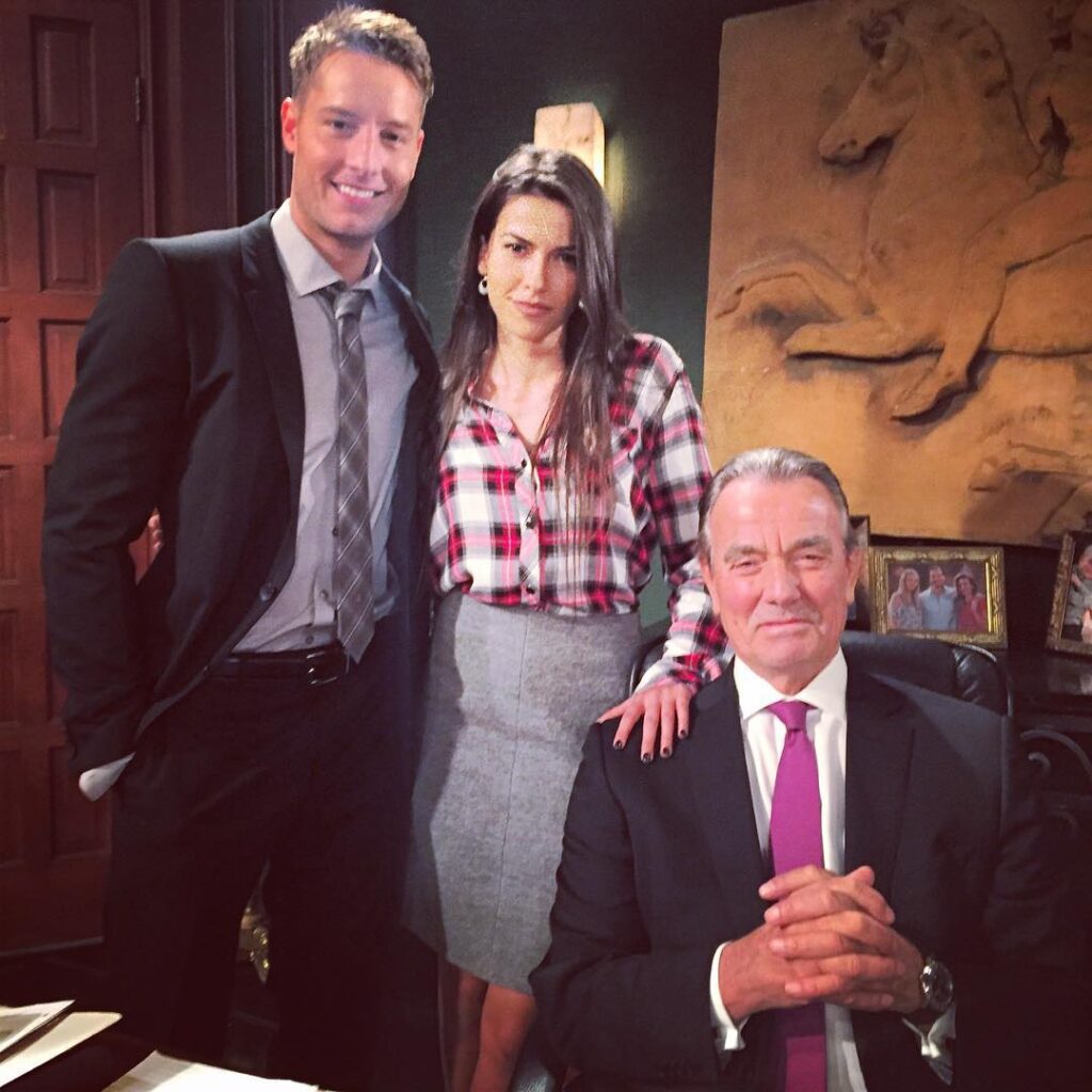 Justin Hartley Sofia Pernas standing next to a sitting Eric Braeden
