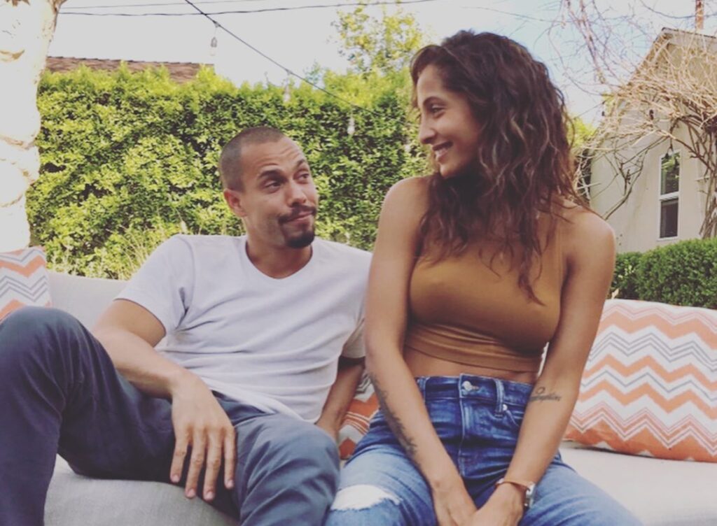 bryton james and christel khalil smiling at each other