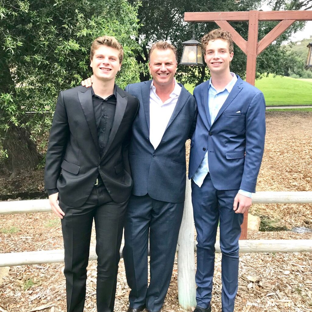 three men in suits standing 