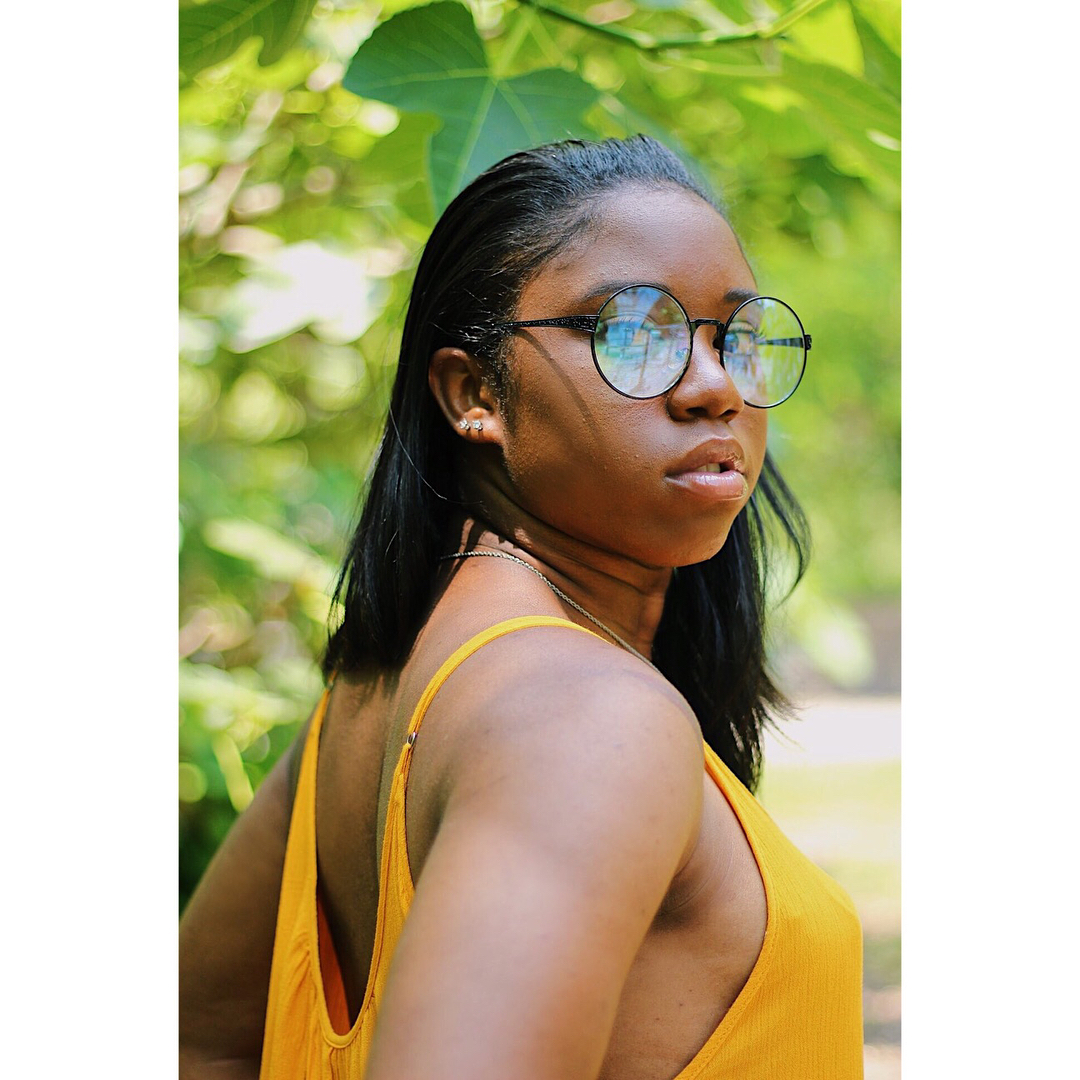 Jamia Simone Nash in yellow bathing suit with spectacles.