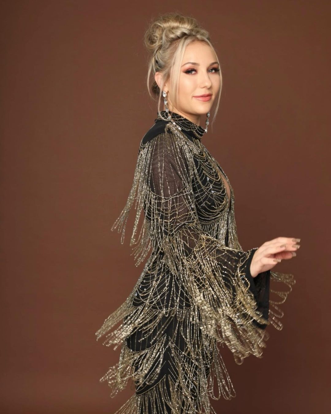 Alexes Marie Pelzer wearing black dress with golden beads