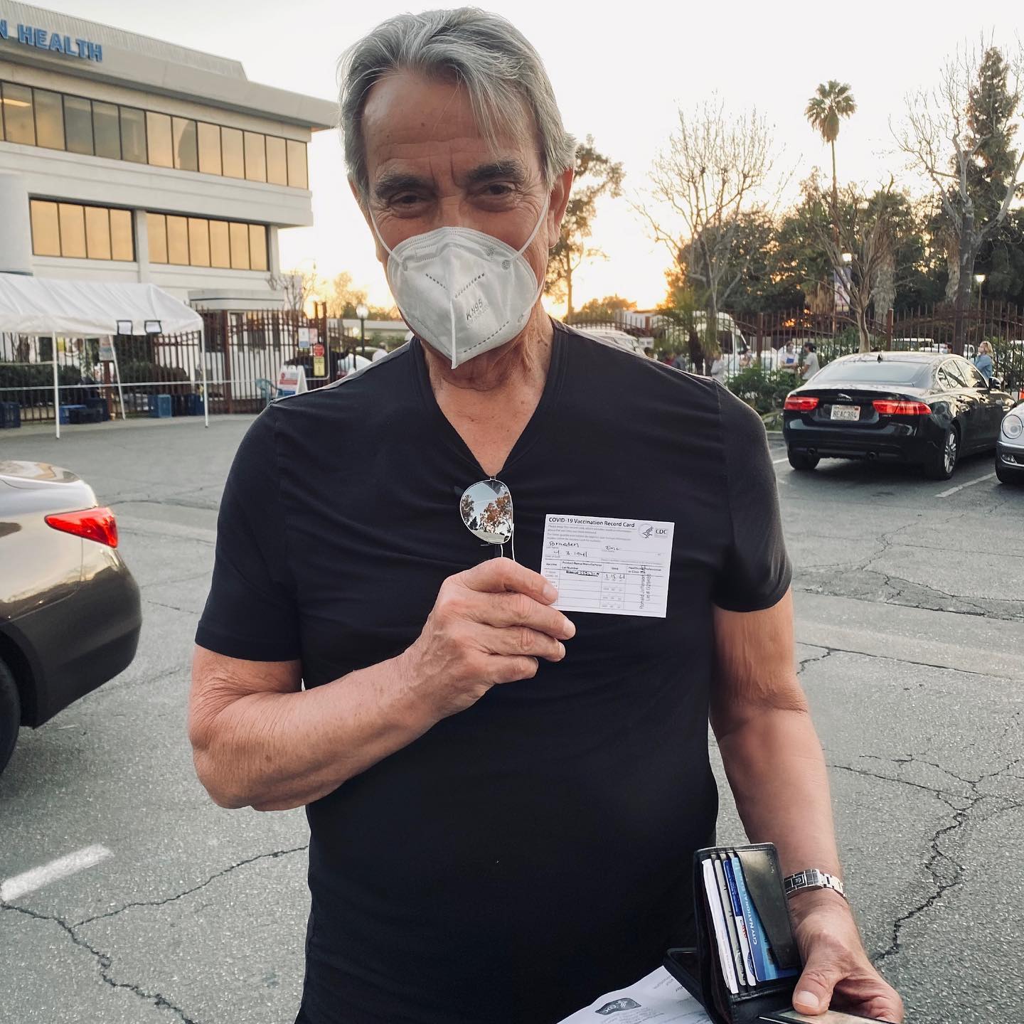 Eric Braeden holding his COVID vaccine card.