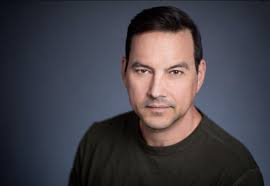 Tyler Christopher's image with blue black background. 