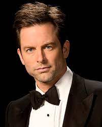 Michael Muhney's self portrait with him wearing black suit and a black bow.