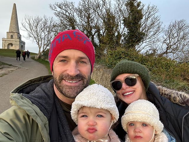 Hayley Erin with husband and two kids, wearing  beanies