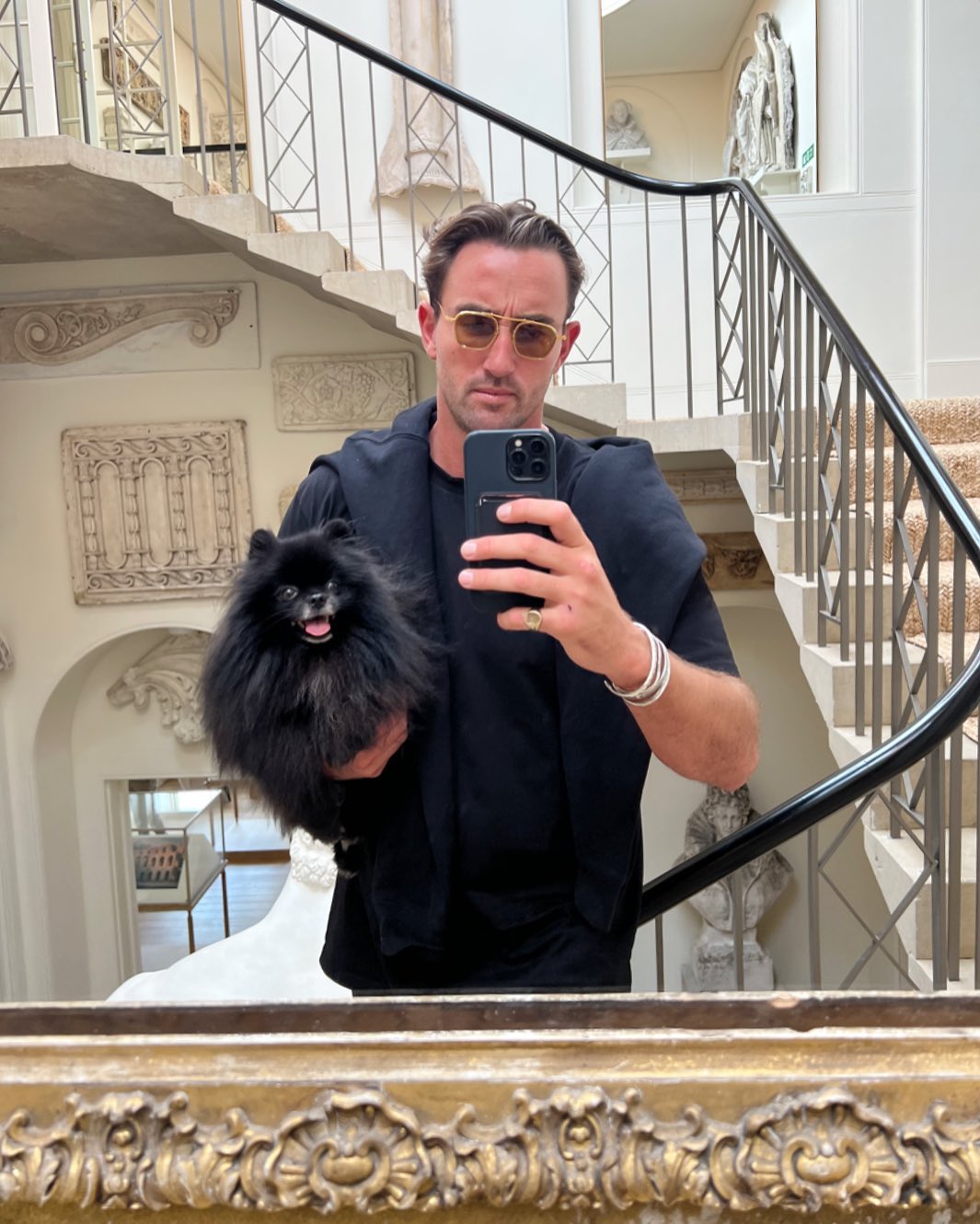 a mirror selfie of Maxwell Shepherd with a dog